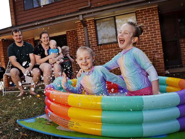 Matt and Caitlin Sabjan worry they might have to limit the days they fill up the paddling pool for daughters Delilah and Ellianah if water prices go up. Picture: Sam Ruttyn