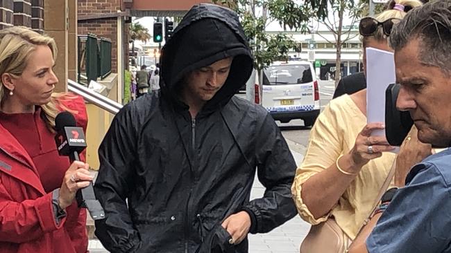 Lincoln Mobbs, 18, of Baulkham Hills, avoids talking to media outside Manly police station on Monday. Picture: Jim O'Rourke