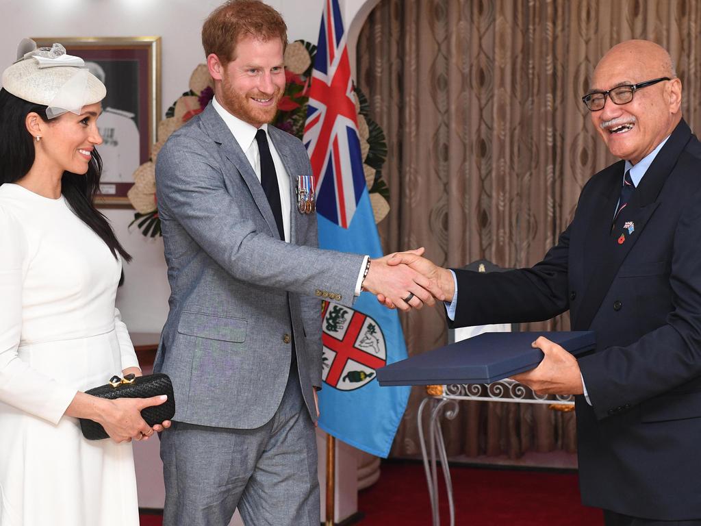 Meghan, Duchess of Sussex and Prince Harry, Duke of Sussex present a gift to the President of Fiji Jioji Konrote on the first day of their tour to Fiji.  Picture:  Getty