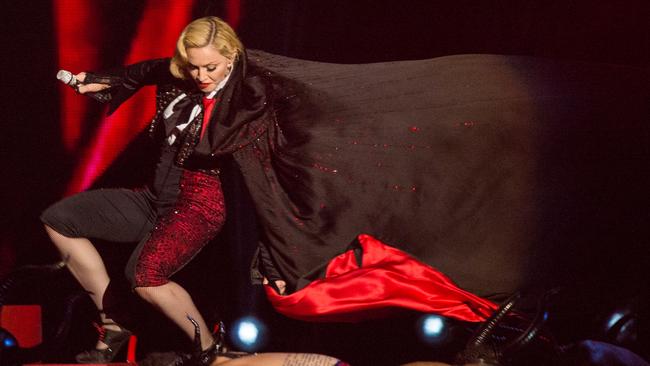 Madonna falls as she performs on stage for the BRIT Awards.