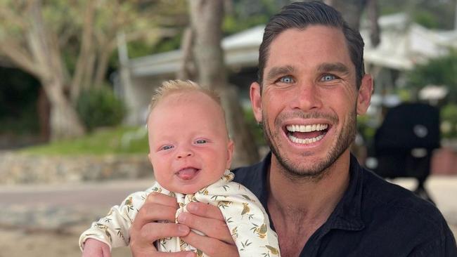 Geelong premiership star Tom Hawkins with his son Henry in Queensland.