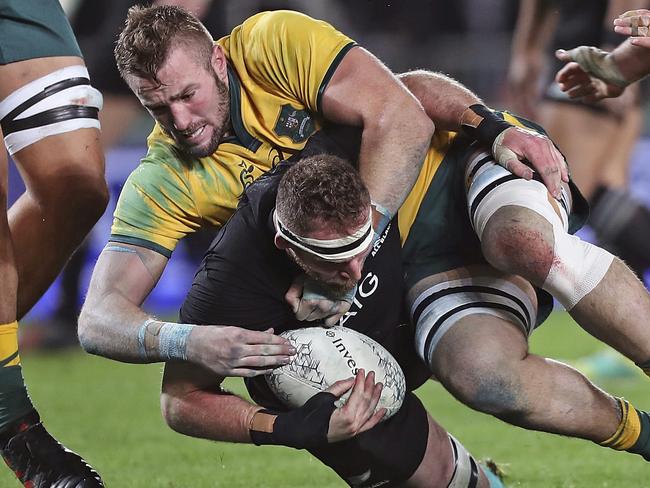 Australia's Izack Rodda, top, tackles New Zealand's Kieran Read in the Bledisloe Cup rugby test match at Eden Park in Auckland, New Zealand, Saturday Aug. 25, 2018. (AP Photo/David Rowland)