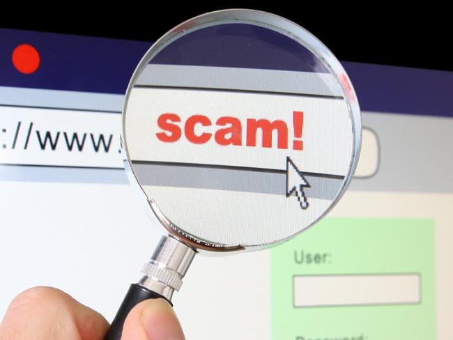 A hand holds a magnifying glass over the location bar of a browser, revealing the URL is a "scam".