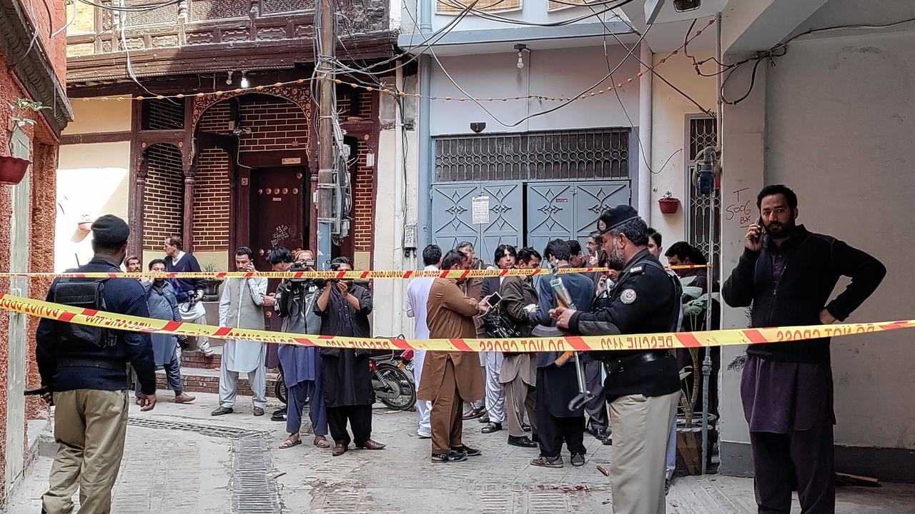 Policemen cordon off a street leading to a mosque after a bomb blast in Peshawar on March 4, 2022. - At least 30 people were killed and 56 wounded in a huge blast at a mosque in the northwestern Pakistani city of Peshawar, a hospital official said on Friday. (Photo by Abdul MAJEED / AFP)