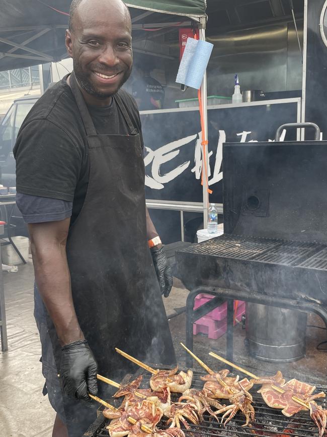 The Real Jerk's Roderick Grant whips up jerk barbecue squid on a stick at Meatstock 2023 at the Melbourne Showgrounds.