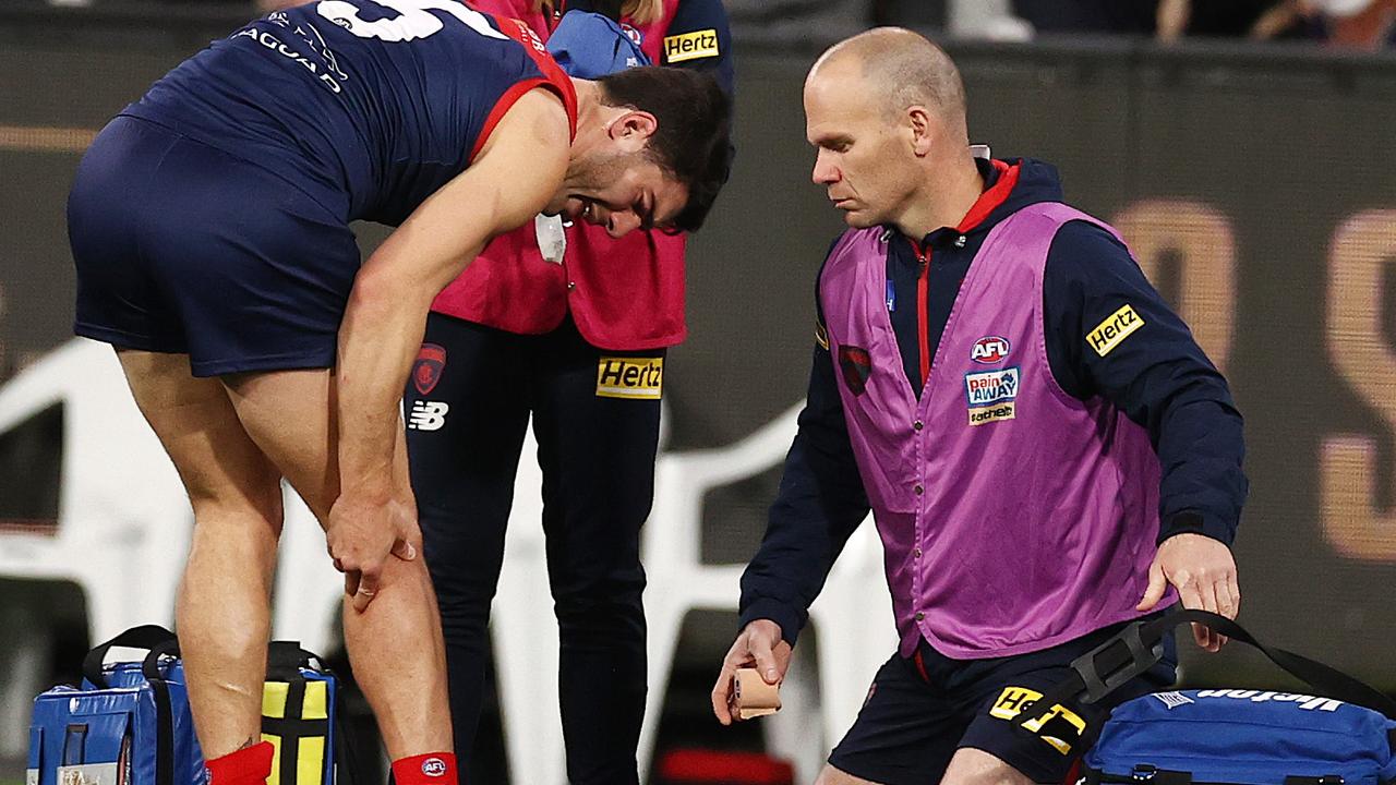 Christian Petracca is attended to by one of the team physios at quarter time. Picture: Michael Klein