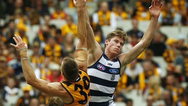 Mark Blicavs jumps over Max Bailey in early April, 2013.