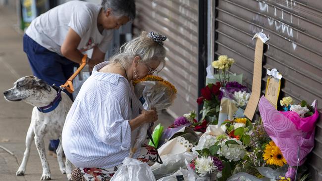 Locals leave flower tributes to the couple outside their shop in Oxford Street, Cambridge Park. Picture: NewsWire / Simon Bullard.