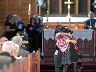 Mourners hug at the funeral service for Geoffrey Cawley, held at St Andrew's Anglican Church in Lismore. Picture: Marc Stapelberg