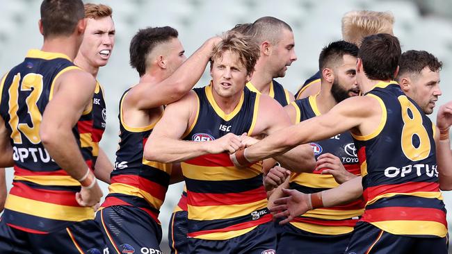 Crows players congratulate captain Rory Sloane (middle) after he kicked a goal in the round one loss to Sydney before the competition was halted. Picture: Sarah Reed