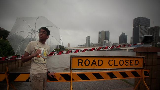 Maharshi Patel, 13, watched the Brisbane River lap the banks adjacent to South Bank Parkland in Brisbane’s CBD, January 11, 2011. Brisbane CBD was deserted as people prepared for expected record flood levels.