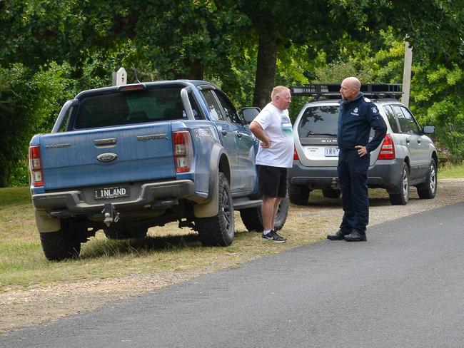 Samantha’s husband speaks to a policeman. Picture: Ian Wilson