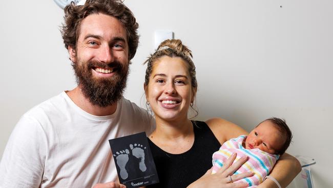 New parents Ryan and Rachel Somes with four-day-old Beau Somes and his baby footprints from the Mater Redlands.