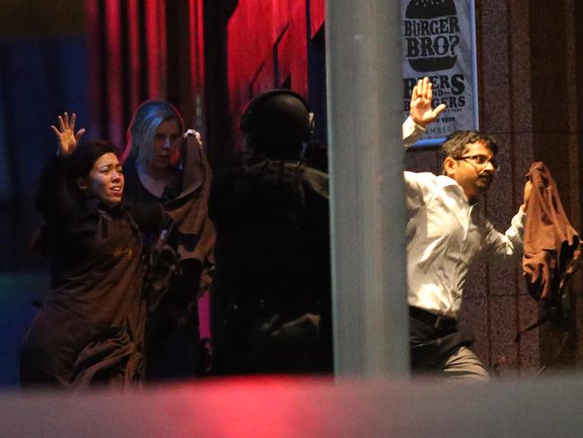 Harriette Denny, Julie Taylor and Viswakanth Ankireddy make their escape. Picture: AP