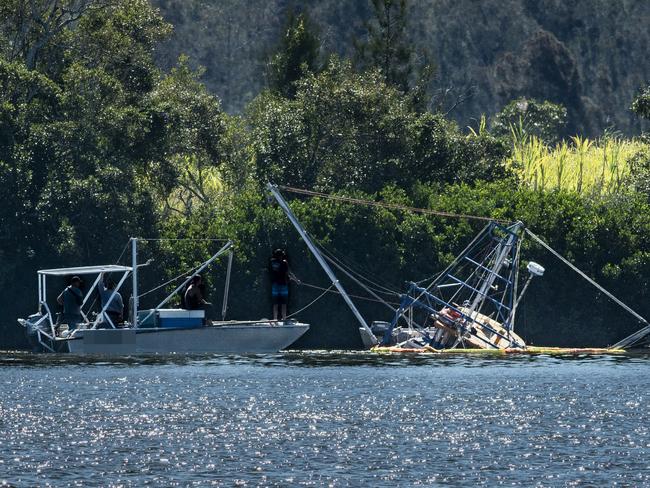 A trawler sits on a mud flat near Maclean after it sank in the Clarence River.