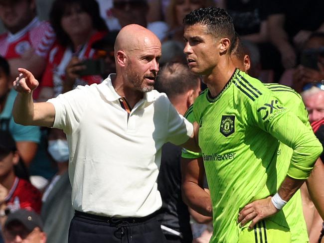 (FILES) In this file photo taken on August 27, 2022 Manchester United's Dutch manager Erik ten Hag (L) directs substitute Manchester United's Portuguese striker Cristiano Ronaldo during the English Premier League football match between Southampton and Manchester United at St Mary's Stadium in Southampton, southern England. - Manchester United said on November 14, 2022 they were "considering their response" to an interview given by star forward Cristiano Ronaldo where he said he felt "betrayed" by the club. (Photo by Adrian DENNIS / AFP) / RESTRICTED TO EDITORIAL USE. No use with unauthorized audio, video, data, fixture lists, club/league logos or 'live' services. Online in-match use limited to 120 images. An additional 40 images may be used in extra time. No video emulation. Social media in-match use limited to 120 images. An additional 40 images may be used in extra time. No use in betting publications, games or single club/league/player publications. /