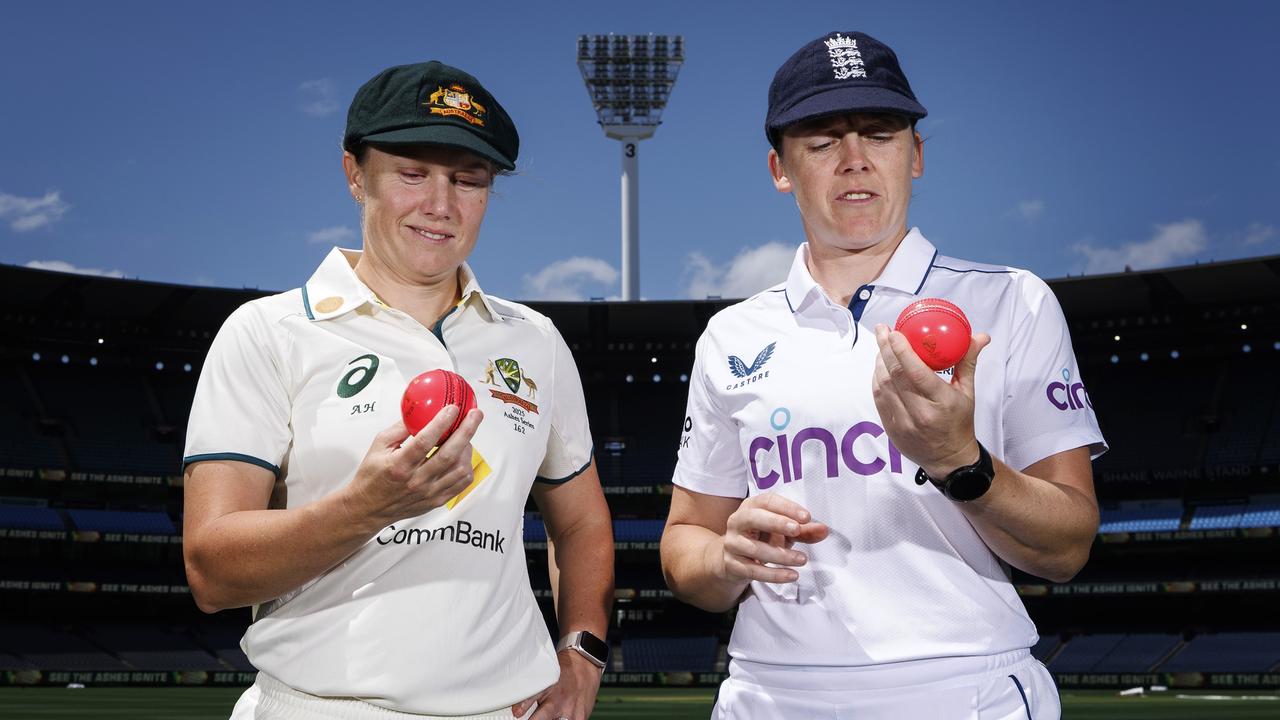 Alyssa Healy of Australia (L) and Heather Knight of England inspect the pink ball being used for the Ashes Test at the MCG. (Photo by Daniel Pockett/Getty Images)