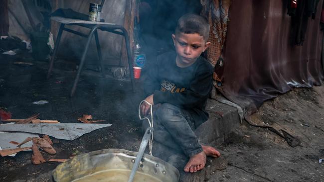 A Palestinian boy waits to breaking the fast on the second day of Ramadan at a camp for displaced people in Rafah in the southern Gaza Strip. Picture: AFP