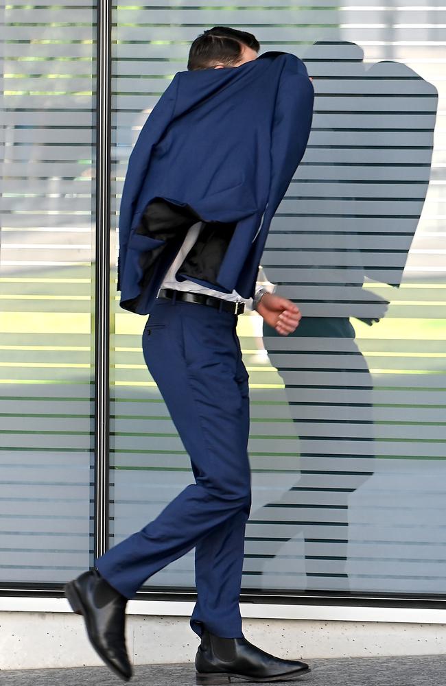 Tyler Phillip Sullivan hides from media as he enters Brisbane Supreme Court. Picture: John Gass