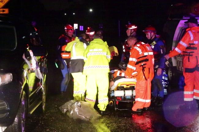 SES crews rescue a person bitten by snake whilst attempting to rescue a man during floods at Auld Avenue in Milperra. Picture: TNV