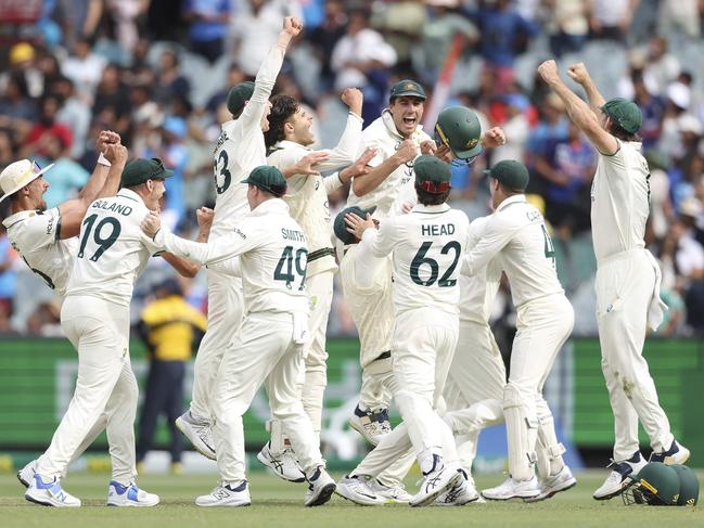 TOPSHOT - Australian players celebrate the final wicket on day five of the fourth cricket Test match between Australia and India at the Melbourne Cricket Ground (MCG) in Melbourne on December 30, 2024. (Photo by Martin KEEP / AFP) / -- IMAGE RESTRICTED TO EDITORIAL USE - STRICTLY NO COMMERCIAL USE --