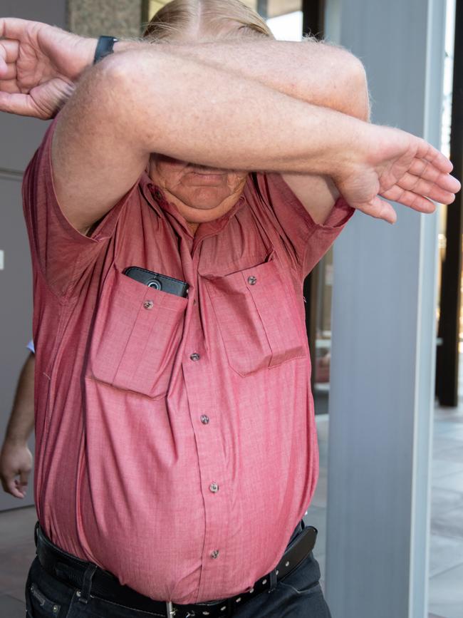 He tried to shield his face from the media. Picture: Monique Harmer