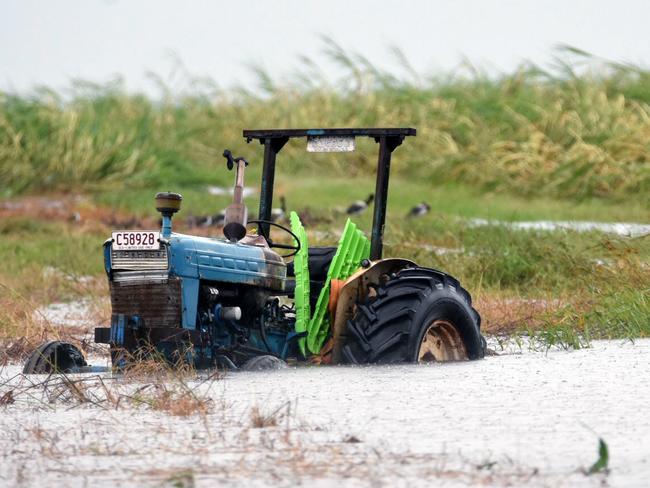 A tractor is seen inundated with water on a property south of Bowen, Queensland, Wednesday, March 29, 2017. Picture: AAP Image/Sarah Motherwell