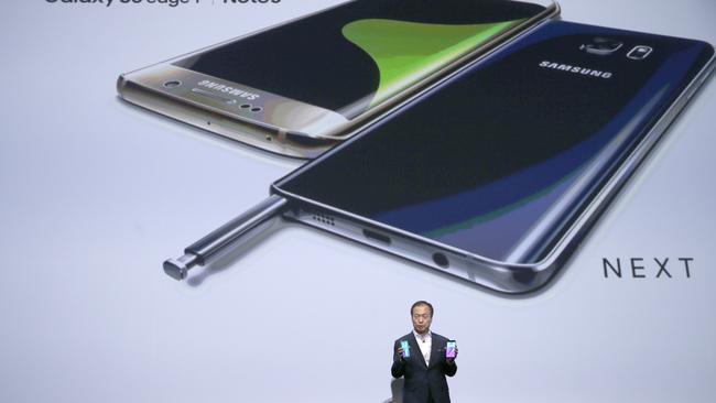 Unveiled ... Samsung Electronics president and CEO JK Shin holds the Samsung Galaxy S6 Edge+, left, and the Samsung Galaxy Note 5 during its launch. Picture: AP Photo/Mary Altaffer