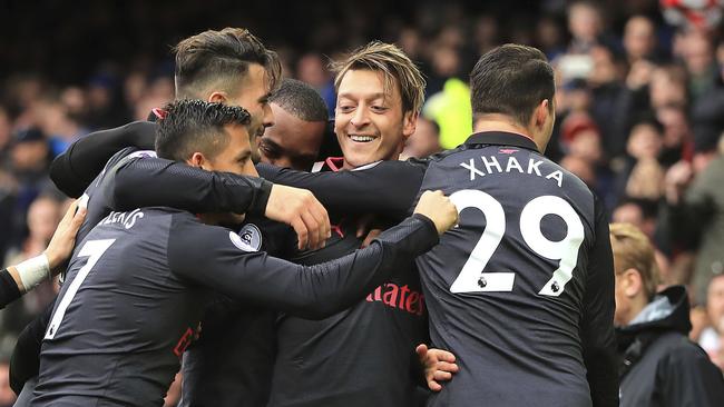 Arsenal's Mesut Ozil (C) celebrates scoring with teammates.