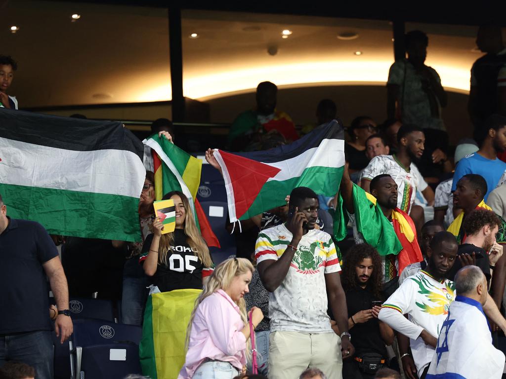 Supporters wave Palestinian flags during the Mali v Israel match at the Parc des Princes in Paris. Picture: AFP