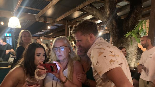 Michael Lyon (right) and supporters keep and eye on the vote tally for the Byron Shire Council election at their campaign celebration event at La Familia in Mullumbimby on December 4, 2021. Picture: Liana Boss