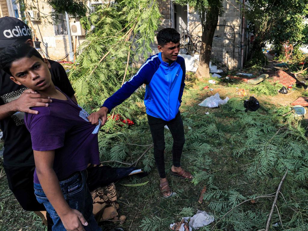 A youth boy reacts while walking at the site of the Ahli Arab hospital in central Gaza. Picture: AFP