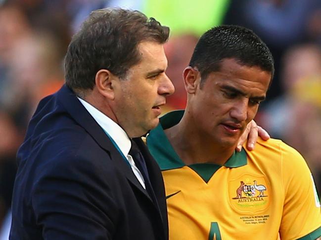 PORTO ALEGRE, BRAZIL - JUNE 18: Tim Cahill of Australia hugs head coach Ange Postecoglou after exiting the game during the 2014 FIFA World Cup Brazil Group B match between Australia and Netherlands at Estadio Beira-Rio on June 18, 2014 in Porto Alegre, Brazil. (Photo by Cameron Spencer/Getty Images)