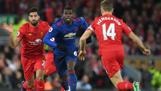 Manchester United's French midfielder Paul Pogba (C) vies with Jordan Henderson.