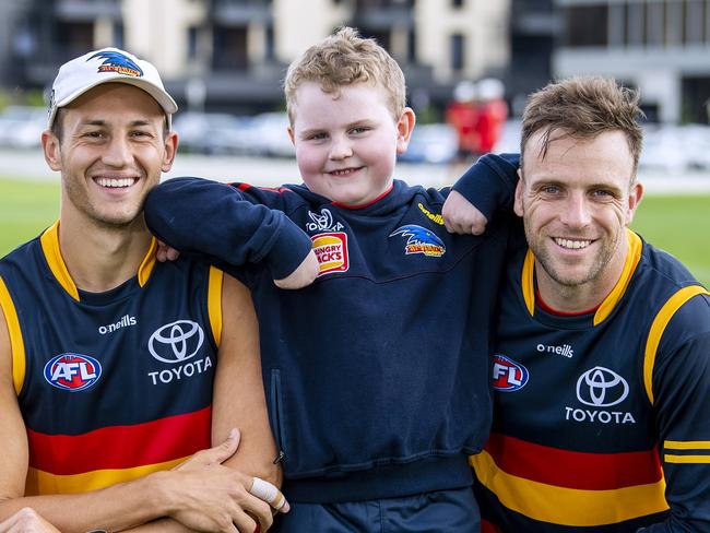 Seven-year-old Crows fan Nash Holmes with Crows players Wayne Milera,Tom Doedee and Brodie Smith after their captains run Nash will run out with the Crows this Showdown.Friday,March,31,2023.Picture Mark Brake