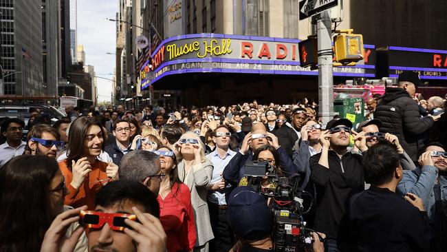 People wear glasses to see the solar eclipse near Fox News Channel Studios in New York City. Picture: John Lamparski/Getty Images