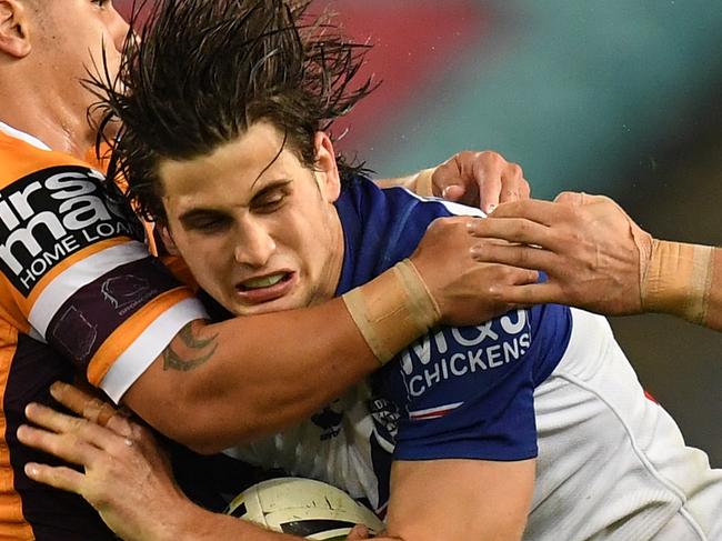 Lachlan Lewis of the Bulldogs is tackled by Kodi Nikorima and James Roberts of the Broncos during the Round 21 NRL match between the Canterbury-Bankstown Bulldogs and the Brisbane Broncos at ANZ Stadium in Sydney, Thursday, August 2, 2018. (AAP Image/Dean Lewins) NO ARCHIVING, EDITORIAL USE ONLY