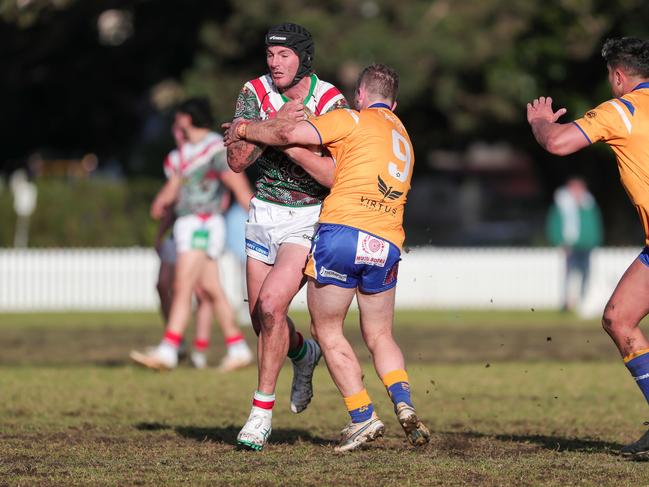 Fraser Graham tackled by Ryan O'Connor. Picture: Adam Wrightson Photography