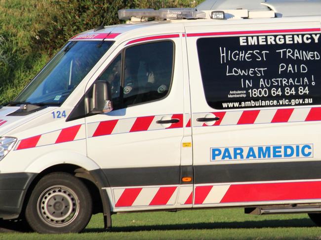 Category:News; Caption:At an under 16s football game in Essendon yesterday an ambulance was called for a player that laid motionless for 15 minutes after a marking contest. When the ambulance arrived most spectators and players were surprised it had been graffiti\'d with slogans relating to pay claims and the salaries of political leaders. (2nd pic); Read the terms and conditions:YesWEBSITE READER PICTURE HWTWayne Brasher , changingpockets@gmail.com, 0425892371,