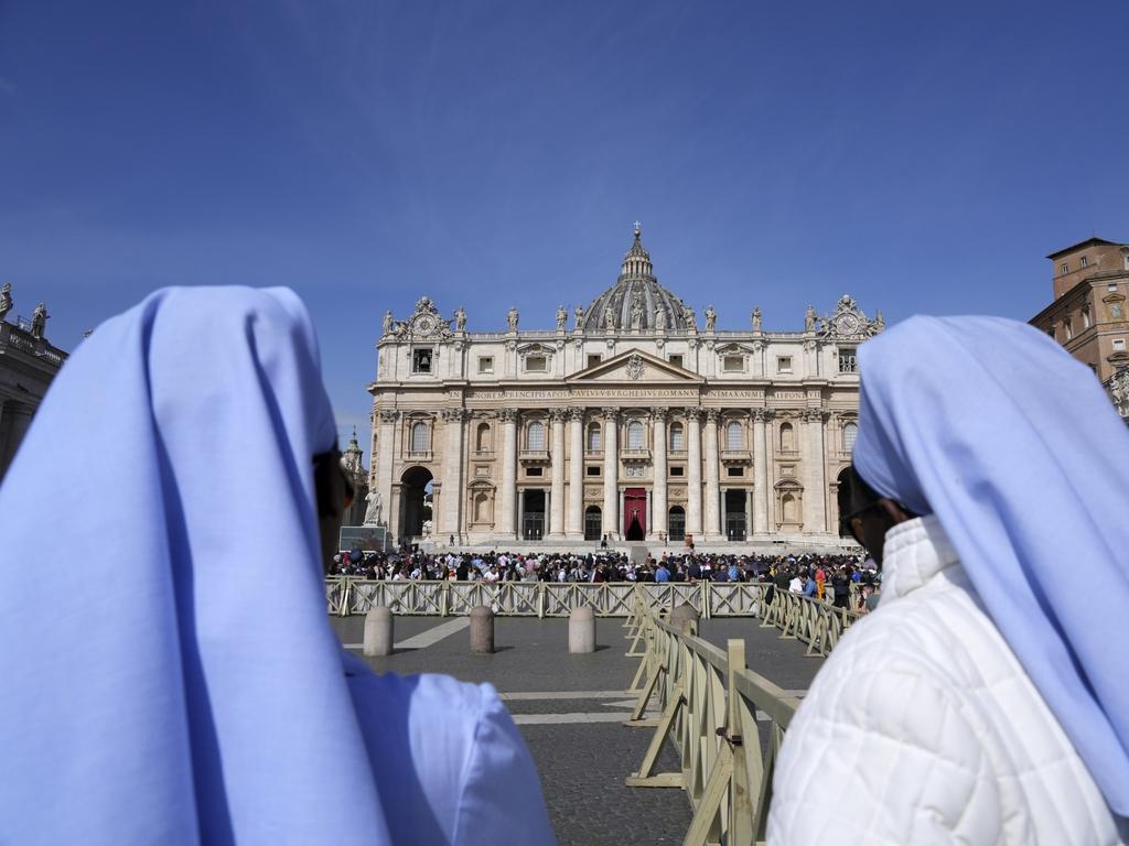 Nuns watch St. Peter's Basilica after the body of Pope Francis was carried through the Square. Picture: AP