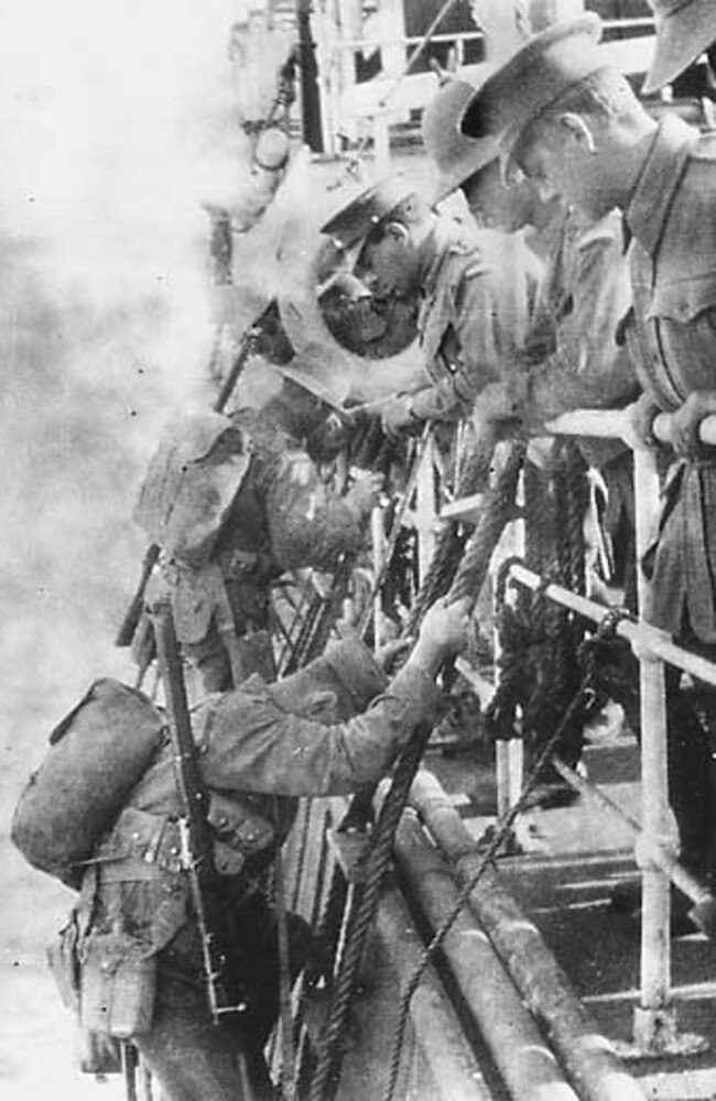 The men begin unloading into smaller landing craft.