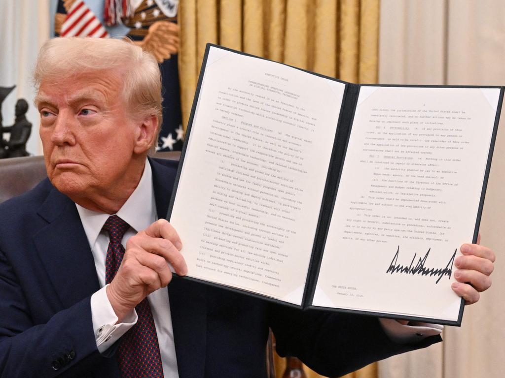 US President Donald Trump holds up an executive order he had signed. He has unleashed a tsunami of change. Picture: Roberto Schmidt/AFP