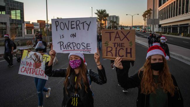 Protesters wearing Santa’s hats march towards an Amazon Book Store in the Marina Del Rey neighbourhood of Los Angeles during a Black Lives Matter rally to demand social justice. California accused Amazon of failing to adequately comply with subpoenas demanding details about coronavirus cases and protocols at its facilities here.