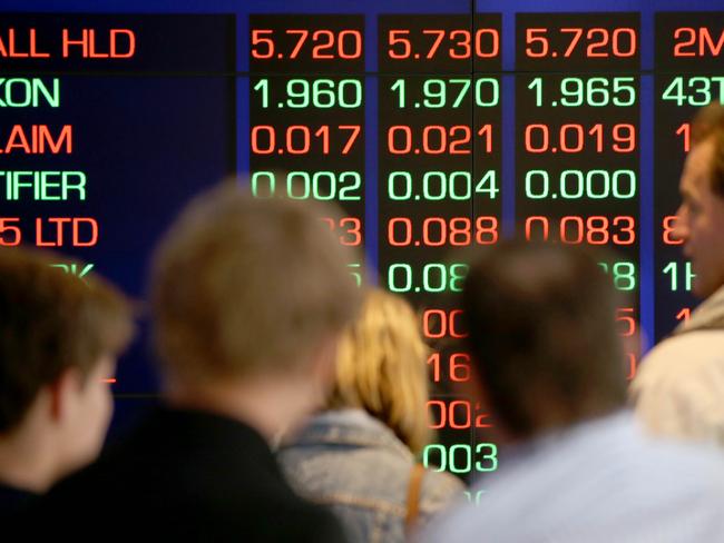 People look at electronic displays at the Australian Stock Exchange in Sydney, Wednesday, Oct. 1, 2014. Asian stocks were mixed Wednesday after Wall Street slid and South Korea reported factory output contracted, while markets in China and Hong Kong were closed for a holiday. (AP Photo/Rick Rycroft)