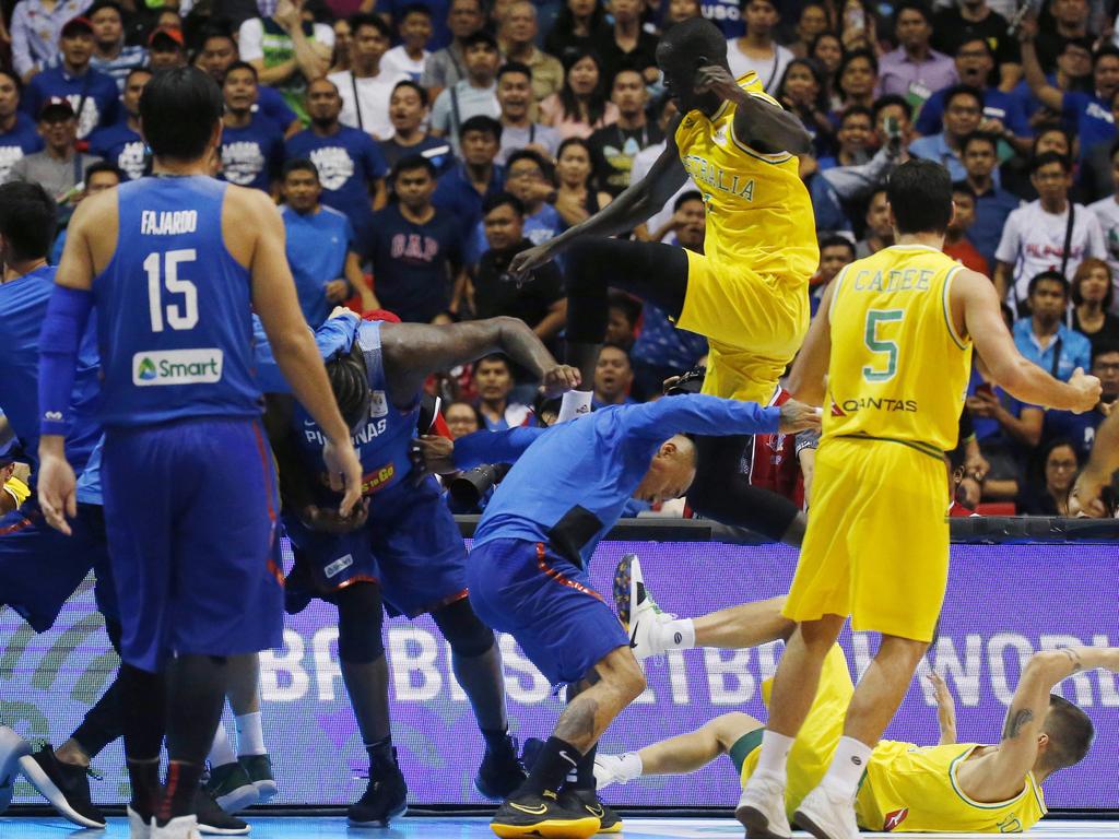 The Philippines players, left and Australian basketball players react, during the FIBA World Cup Qualifiers Monday, July 2, 2018 at the Philippine Arena in suburban Bocaue township, Bulacan province north of Manila, Philippines. Australia defeated the Philippines 89-53 via default following a brawl in the third quarter. (AP Photo/Bullit Marquez)