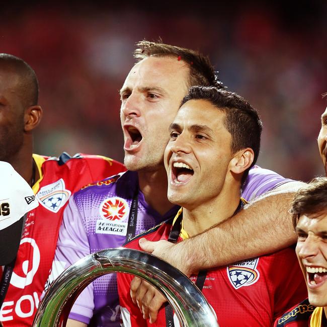 Adelaide United captain Eugene Galekovic and Marcelo Carrusca celebrate with the trophy after the 2015/16 A-League Grand Final 3- 1 win over Western Sydney Wanderers at Adelaide Oval on May 1, 2016. Picture: Morne de Klerk/Getty Images