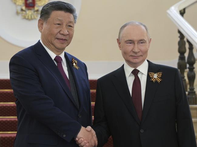 Chinese President Xi Jinping and Russian President Vladimir Putin shake hands during their meeting before the Victory Day military parade in Moscow on May 9. Picture: Photo host agency RIA Novosti via AP