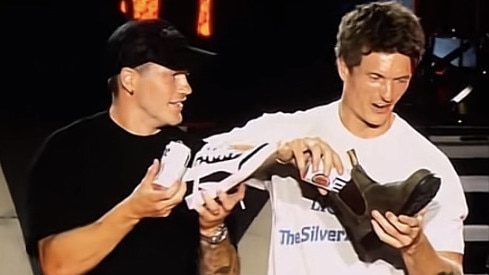 Collingwood players Jack Crisp and Brody Mihocek do a shoey on stage with Luke Combs. Picture: Supplied