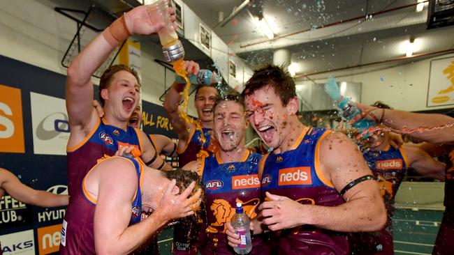 Brisbane Lions players celebrate knocking off the reigning premier Eagles in Round 1. Picture: AAP Image/Darren England