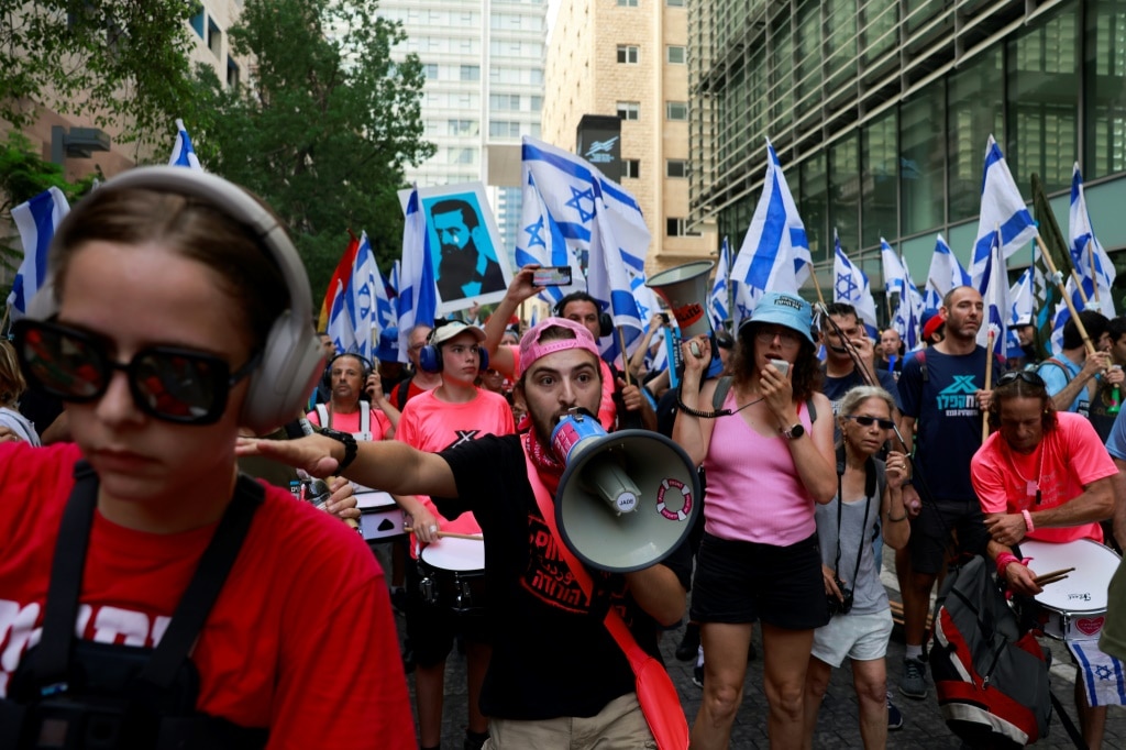 Israelis throng train stations, block roads to protest judicial reforms ...